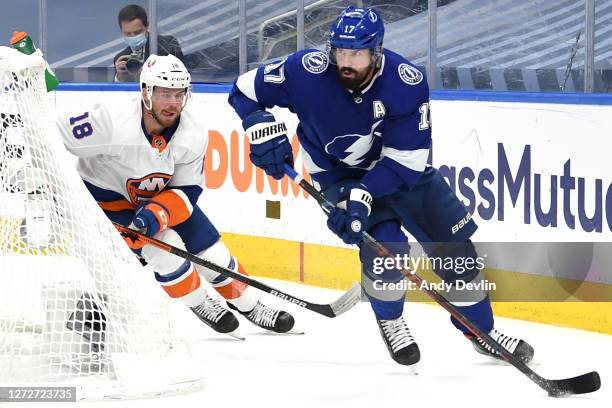 Alex Killorn of the Tampa Bay Lightning looks to make a play with the puck as Anthony Beauvillier of the New York Islanders pursues the play in the...