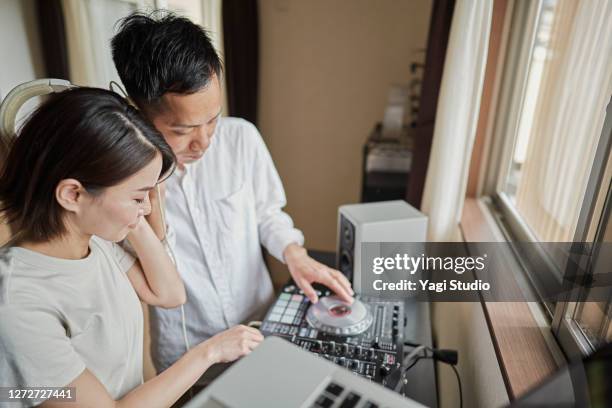 japanse couple  enjoy djing as a hobby at home - djiang stock pictures, royalty-free photos & images