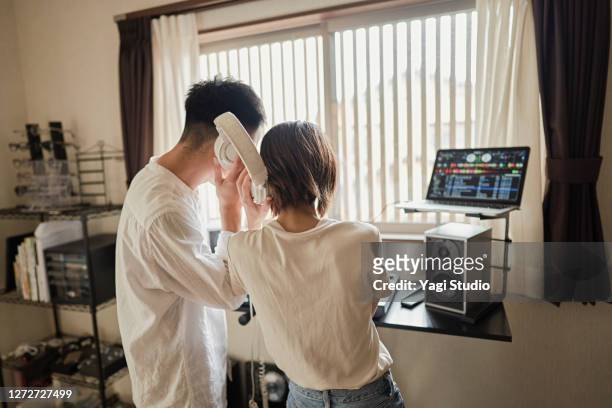japanse couple  enjoy djing as a hobby at home - djiang stock pictures, royalty-free photos & images