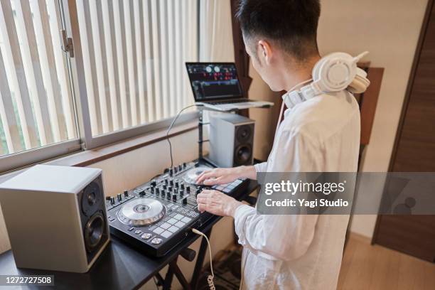 japanese men enjoy djing as a hobby at home - djiang stock pictures, royalty-free photos & images