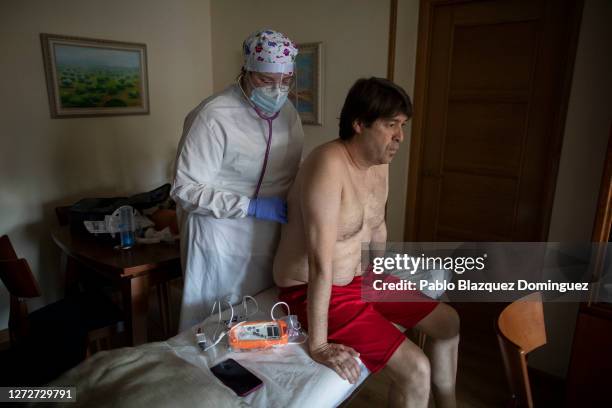 Physiotherapist from the clinic Fisiobronquial, Noelia Rama Suárez uses a stethoscope to check the lungs of patient Carlos Rodríguez 50, who was...