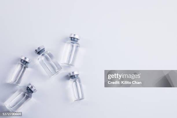 overhead view of vials of vaccine or medicine - phiole stock-fotos und bilder