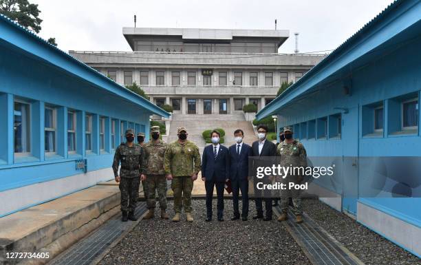 South Korean Unification Minister Lee In-young and officials pose with U.S. And South Korean army soldiers at the military demarcation line during a...