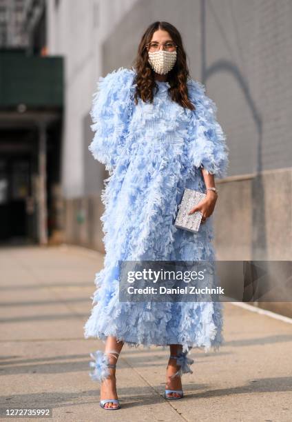 Caroline Vazzana is seen wearing a baby blue dress and heels with a marble sparkled clutch outside the Rebecca Minkoff show during New York Fashion...