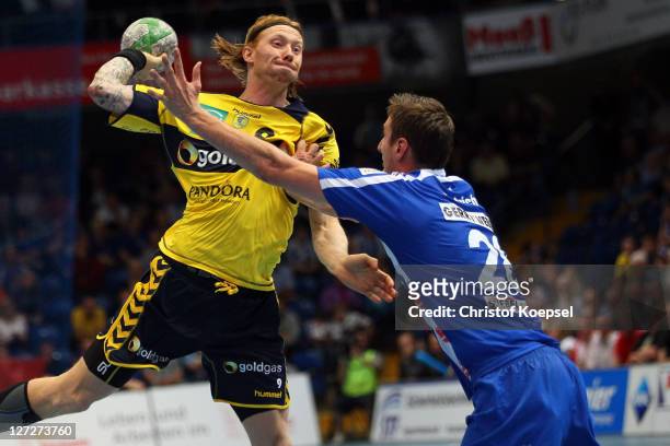 Gunnar Dietrich of Lemgo defends against Bjoerge Lund of Rhein-Neckar Loewen during the Handball Bundesliga match between TBV Lemgo and Rhein Neckar...