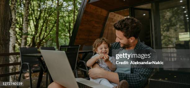 working from a remote location with my boy - log cabin stock pictures, royalty-free photos & images