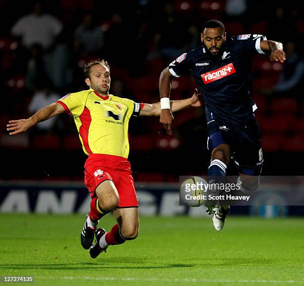 John Eustace of Watford slides in on Liam Trotterof Millwall during the npower Championship match between Watford and Millwall at Vicarage Road on...
