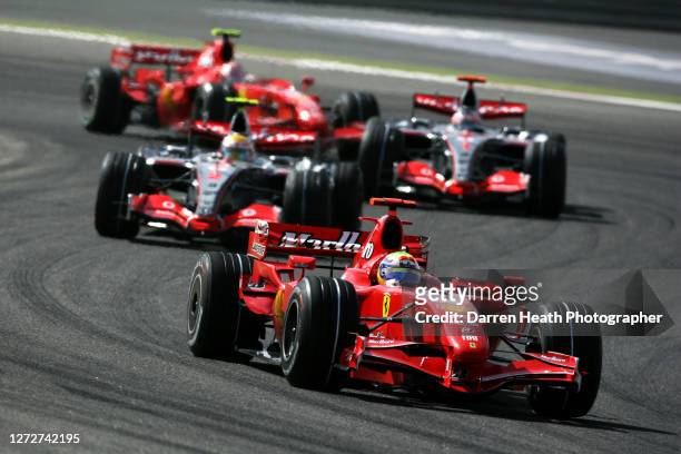 Brazilian Formula One driver Felipe Massa drives his Ferrari F2007 V8 Formula One car ahead of, front to rear, Lewis Hamilton in his McLaren MP4-22...