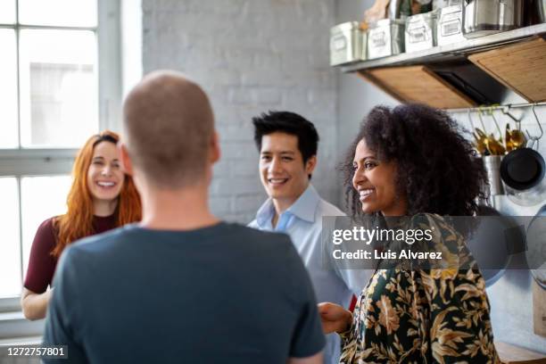 multi-ethnic group having a coffee break in office - colleagues in discussion in office conference room fotografías e imágenes de stock