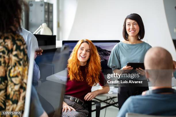 corporate professionals having a meeting in office - middelste deel stockfoto's en -beelden