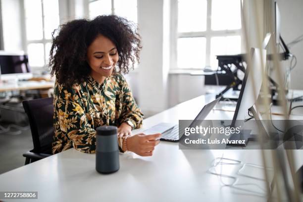 woman using wireless technology for online shopping - ai speaker stock pictures, royalty-free photos & images