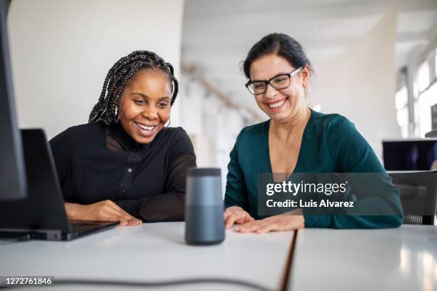 female colleagues using virtual assistant in office - ai assistant stock pictures, royalty-free photos & images