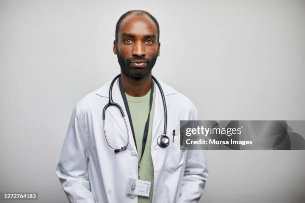 african american male doctor with stethoscope on white background - african male portrait imagens e fotografias de stock