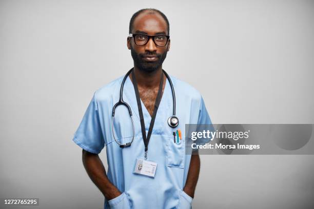 african american doctor/nurse with stethoscope on white background - rassengleichheit stock-fotos und bilder