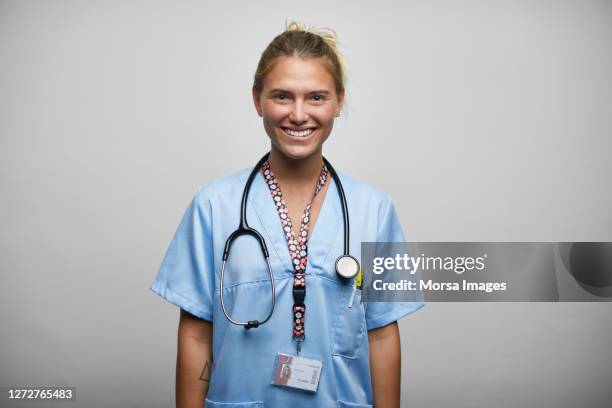 young nurse with stethoscope on white background - auscultation woman stockfoto's en -beelden