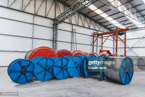 large coils with cable wire in factory warehouse - cable spool stock pictures, royalty-free photos & images