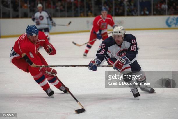 Frantisek Kucera of the Czech Republic tries to get around Pat LaFontaine of the USA at the Big Hat Arena during the 1998 Olympic Winter Games in...