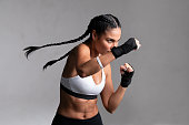 Woman boxer punching during training