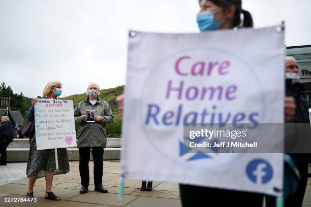 Relatives stage a demonstration over care home coronavirus visiting rules outside the Scottish Parliament on September 16, 2020 in Edinburgh,...