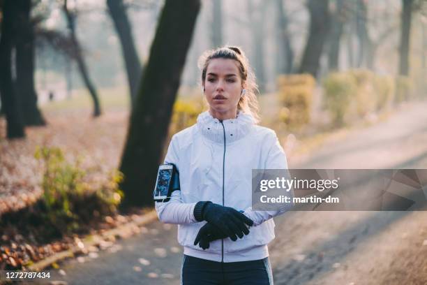 sportswoman portrait in the park - white glove phone stock pictures, royalty-free photos & images