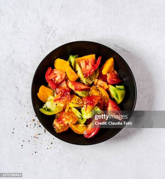 bowl of tomato salad on white background - tomato salad stock pictures, royalty-free photos & images