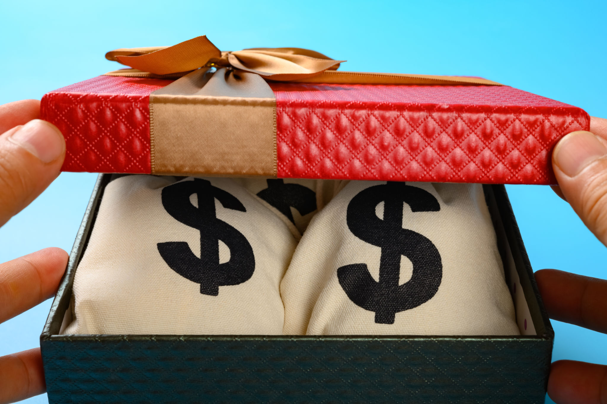 opening a gift box full with US dollar bags carefully opening a gift box full with US dollar bags carefully