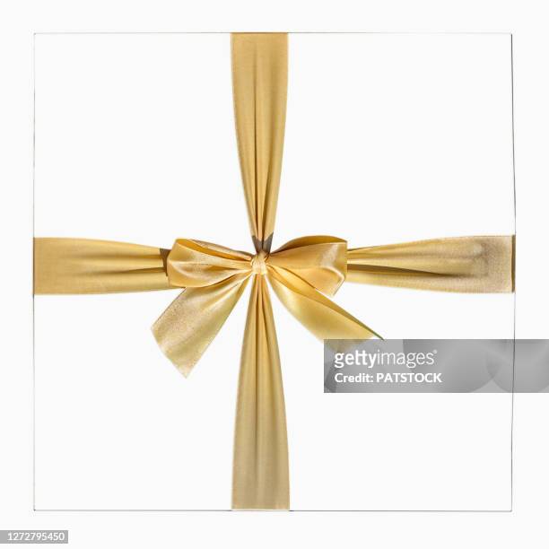 elegant white gift box with golden tied ribbon - schleife stock-fotos und bilder