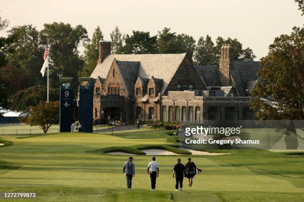 Tiger Woods of the United States walks to his approach shot on the ninth hole as the clubhouse is seen during a practice round prior to the 120th...