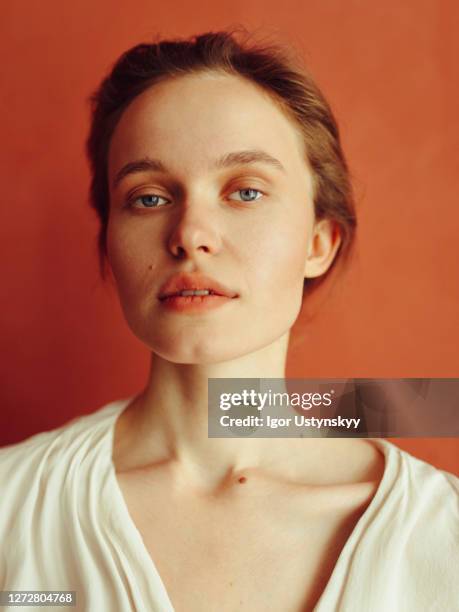 portrait of young beautiful woman looking calm - terracotta stock-fotos und bilder