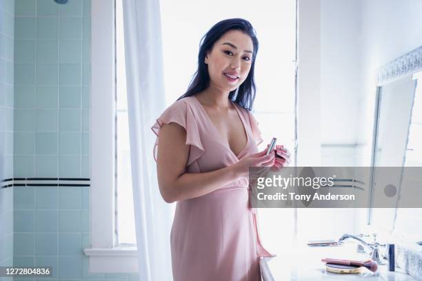young woman in bathroom - pink dress stock pictures, royalty-free photos & images