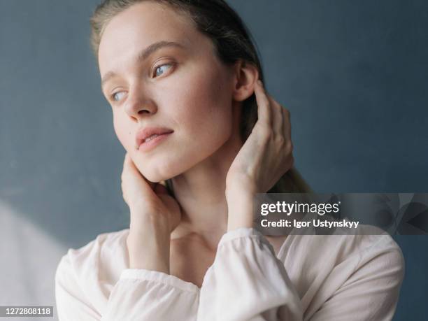 close-up of young beautiful blue-eyed woman - fresh white portrait stock pictures, royalty-free photos & images