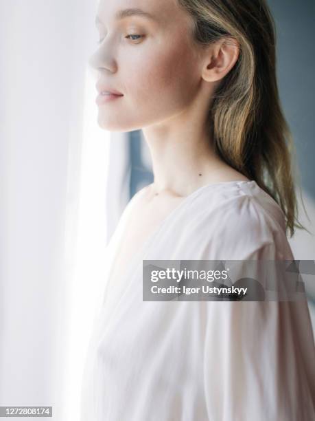 profile view of young woman with long hair - studio shot lonely woman stock pictures, royalty-free photos & images