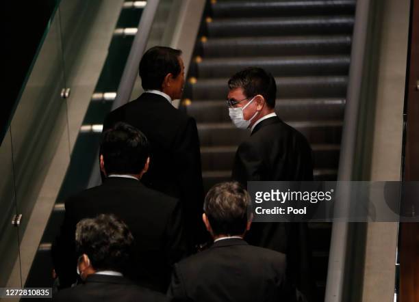 Japan's Deputy Prime Minister and Finance Minister Taro Aso and Administrative Reform Minister Taro Kono leave a photo session with Prime Minister...