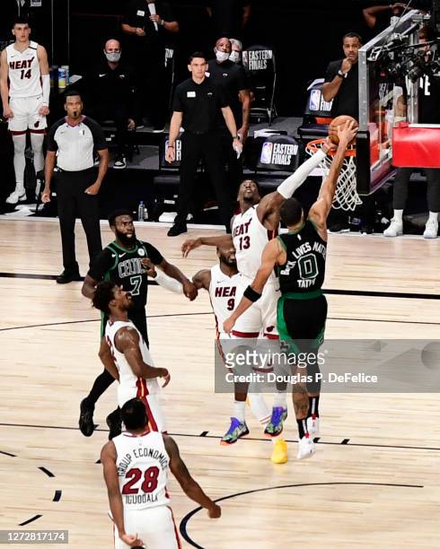 Bam Adebayo of the Miami Heat blocks a shot from Jayson Tatum of the Boston Celtics in the final seconds of overtime to defeat the Boston Celtics by...