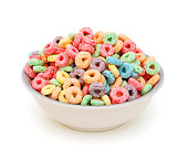 Delicious and nutritious fruit cereal loops flavorful on white background, healthy and funny addition to kids breakfast