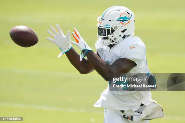 Jordan Howard of the Miami Dolphins catches a pass during a drill at practice at Baptist Health Training Facility at Nova Southern University on...