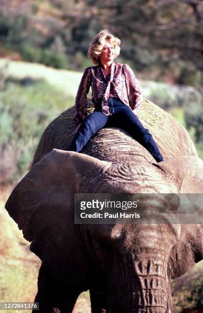 Actress Tippi Hedren, mother of Melanie Griffiths, star of the Alfred Hitchcock horror film The Birds sits astride an Elephant at her Saugus Animal...