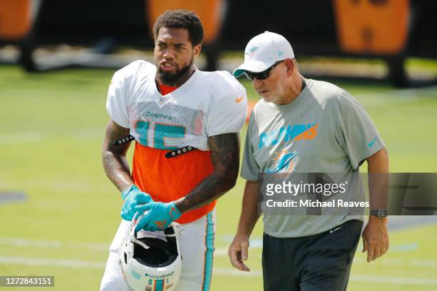 Lynn Bowden Jr. #15 of the Miami Dolphins talks with offensive coordinator Chan Gailey during practice at Baptist Health Training Facility at Nova...