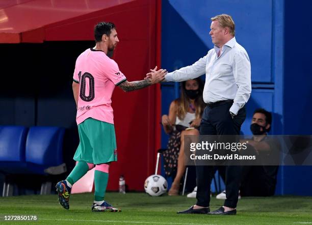 Lionel Messi of Barcelona shakes hands with Ronald Koeman, Manager of FC Barcelona after he is substituted during the pre-season friendly match...
