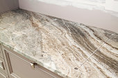 marble countertop with prepared incision for cooktop hob during renovation in modern kitchen
