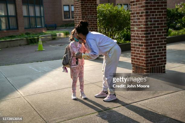 Mother kisses her daughter while dropping her off for class at Stark Elementary School on September 16, 2020 in Stamford, Connecticut. Most students...