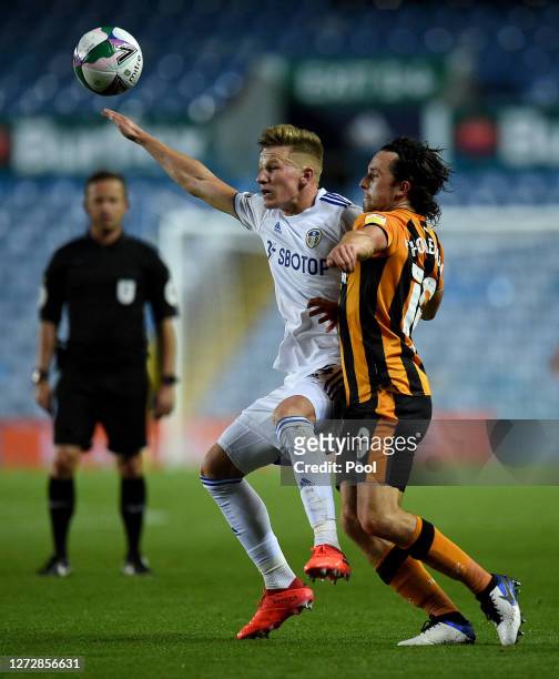 Mateusz Bogusz of Leeds United is challenged by George Honeyman of Hull City during the Carabao Cup Second Round match between Leeds United and Hull...
