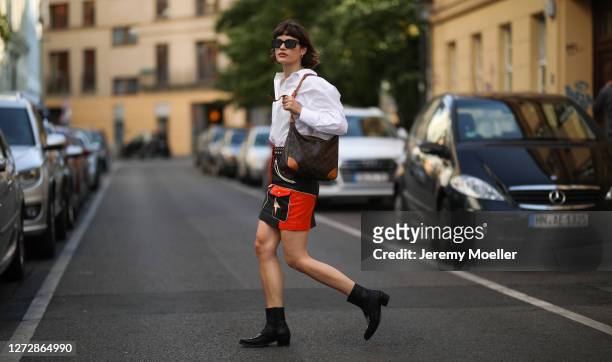 Lea Neumann wearing white shirt, leather vintage skirt, Louis Vuitton bag, Messy Weekend shades and black boots on September 12, 2020 in Berlin,...