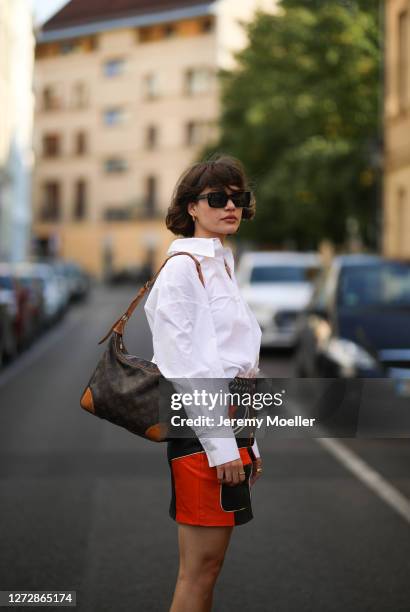 Lea Neumann wearing white shirt, leather vintage skirt, Louis Vuitton bag and Messy Weekend shades on September 12, 2020 in Berlin, Germany.