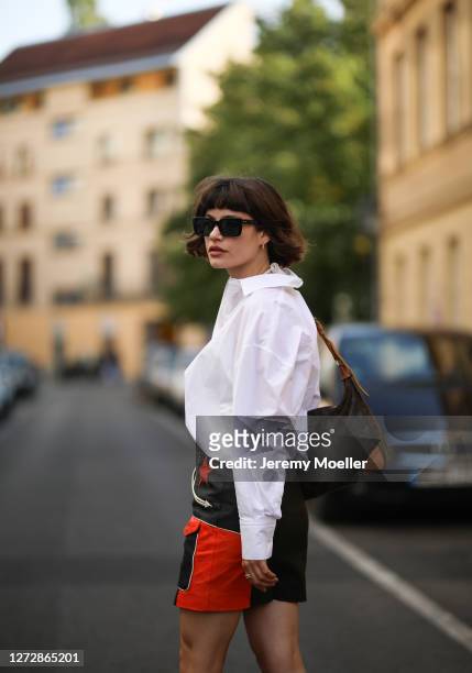 Lea Neumann wearing white shirt, leather vintage skirt, Louis Vuitton bag and Messy Weekend shades on September 12, 2020 in Berlin, Germany.