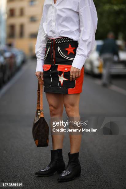 Lea Neumann wearing white shirt, leather vintage skirt, Louis Vuitton bag and black boots on September 12, 2020 in Berlin, Germany.