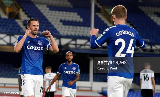 Gylfi Sigurdsson of Everton celebrates with teammate Anthony Gordon after scoring his team's second goal during the Carabao Cup Second Round match...