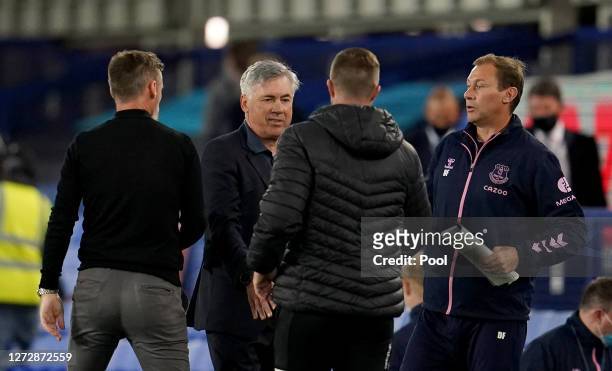 Carlo Ancelotti, Manager of Everton and Duncan Ferguson, assistant manager of Everton speak with Graham Alexander, Manager of Salford City following...