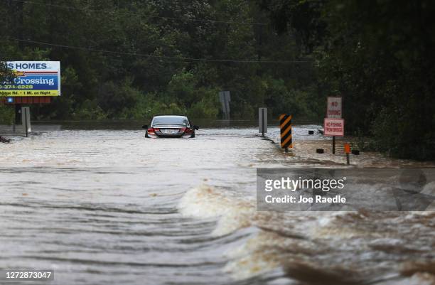 Vehicle is seen abandoned in a flooded road after Hurricane Sally passed through the area on September 16, 2020 in Pensacola, Florida. The storm...