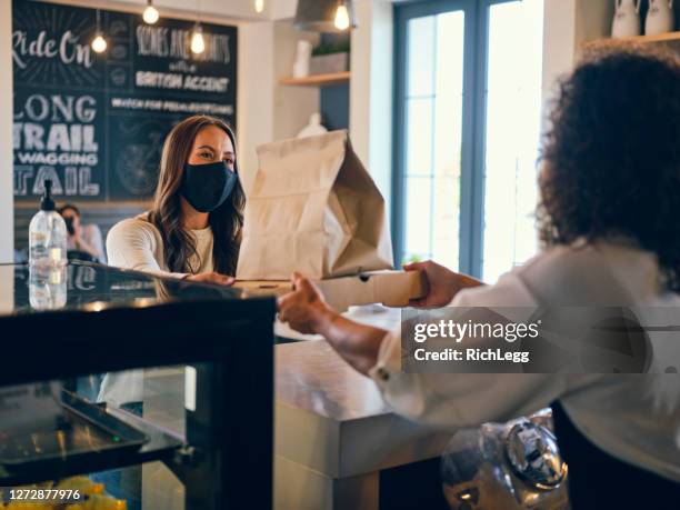 picking up take out food in a cafe - picking up coffee stock pictures, royalty-free photos & images